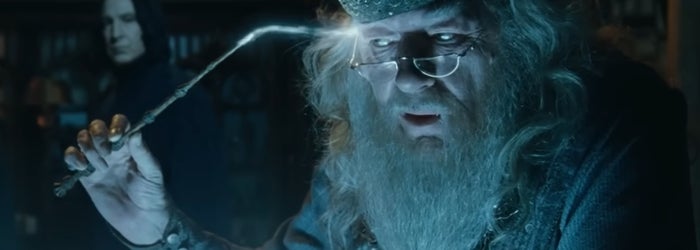 Dumbledore using a glowing wand to remove a memory, Snape standing behind him